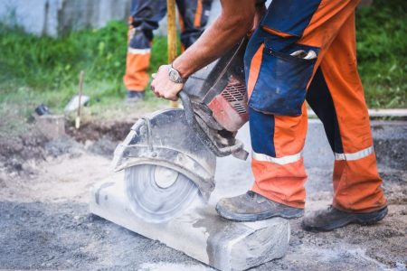 Construction Worker Cutting Concrete Paving Stabs Or Metal For S